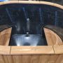 Oval hot tub with thermo clading
