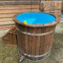 Hot tub with double bottom and side water outlet